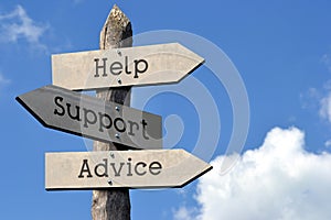 Help, support, advice - wooden signpost with three arrows