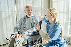 Help support retirement healthcare. Nurse helping old man in wheelchair. Patient and woman in nursing home for medical