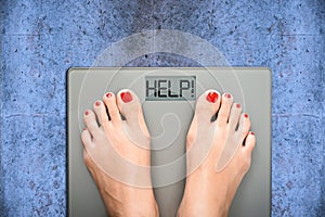 Help to lose kilograms with woman feet stepping on a weight scale