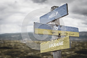 help to ukraine text quote on wooden signpost outdoors, written on the ukranian flags