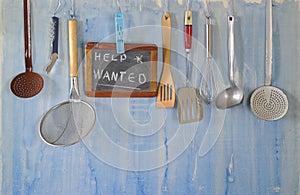 Help wanted sign,restaurant or cafe looking for staff after corona lockdown, kitchen utensils and job posting on blackboard