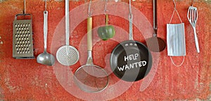 Help wanted sign,restaurant or cafe looking for staff after corona lockdown, kitchen utensils and message on frying pan