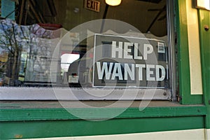 Help Wanted sign in window of small business