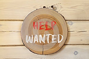 Help wanted and support symbol. Concept words Help wanted on beautiful wooden circle. Beautiful wooden wall background. Business,