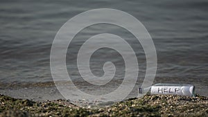 Help word hidden in bottle lying near sea, request for salvation, secret message