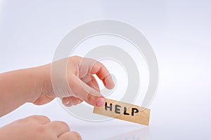 Help word on a piece paper  in hand