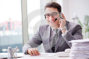 The helpdesk operator talking on phone in office