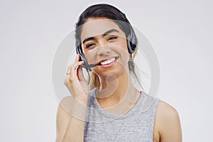 Helpful advice is just a call away. Studio portrait of an attractive young female customer service representative