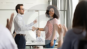 Helpful boss handshaking happy african employee congratulating promoting rewarding worker