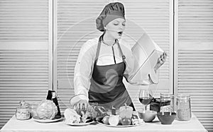 Helpful culinary book. Woman chef cooking food. Culinary concept. Amateur cook read book recipes. Girl learn recipe