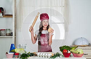 Helpful tools. teen girl chef wearing uniform. child study how to cook by recipe