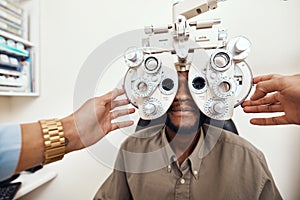 Helping customers see better one eye test at a time. an optometrist examining her patients eyes with an optical