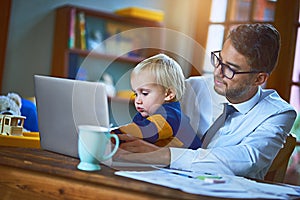 Helping Daddy with his work. a single father and his son using a laptop at home.