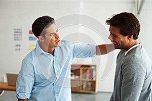 Helping a devastated friend. A young man consoling his sobbing friend.