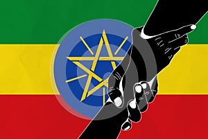 Helping hand against the Ethiopia flag. The concept of support. Two hands taking each other. A helping hand for those injured in