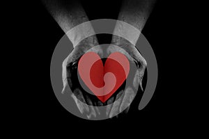 Helping hand concept, Man`s hands palms up holding a Red Heart, giving love, care and support, reaching out