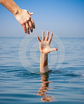 Helping hand giving to drowning man