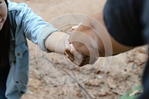 Helping hand outstretched to a woman.