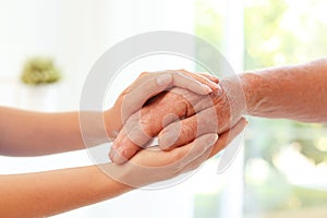 Helping hands on blurred background,