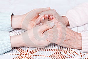 Helping hands, care for the elderly concept. Care is at home of elderly.