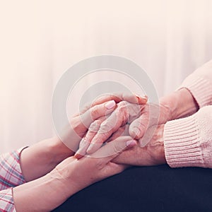 Helping hands, care for the elderly concept. Close-up handshake