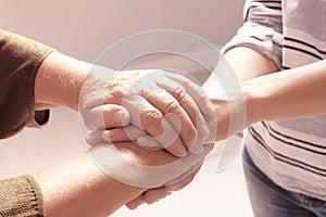 Helping hands on grey background