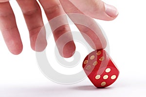 Helping your luck, cheating in games, dishonesty concept. A human finger pushing over a dice to make it show a six