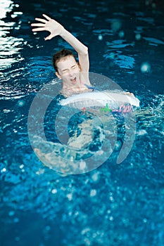 Helpless child drawing in indoor pool