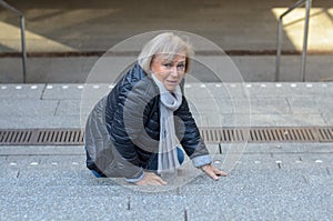 Helpless senior woman falling down steps