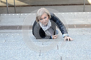 Helpless senior woman falling down steps