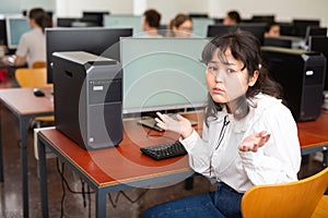 Helpless teenage schoolgirl in computer class