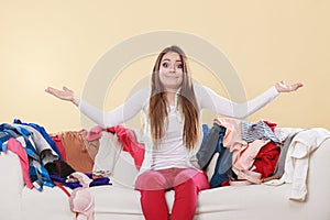 Helpless woman sitting on sofa in messy room home.