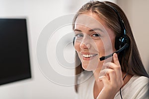 Helpline female operator with headphones in call centre.Business woman with headsets working in a call center. Selective