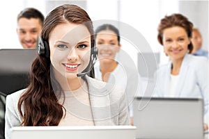 Helpline operator with headphones in call centre