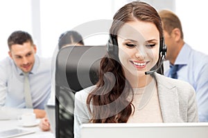 Helpline operator with headphones in call centre