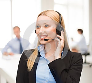 Helpline operator with headphones in call centre