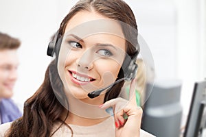 Helpline operator with headphones in call centre