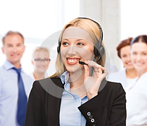 Helpline operator with headphones in call centre