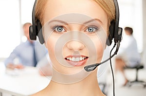 Helpline operator with headphones in call centre