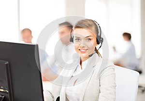 Helpline operator with headphones in call centre