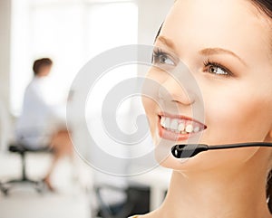 Helpline operator with headphones in call centre