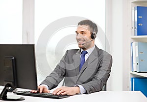 Helpline operator with headphones and computer