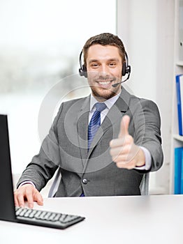 Helpline operator with headphones and computer