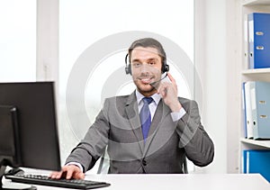 Helpline operator with headphones and computer