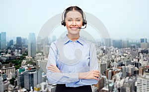 Helpline operator in headset over city background