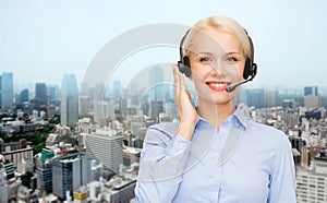 Helpline operator in headset over city background