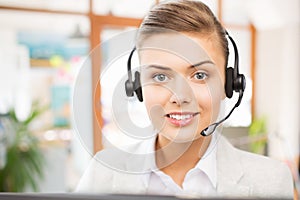 Helpline operator in headset working at office