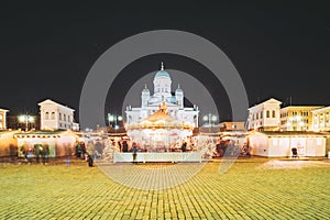 Helsinki, Finland. Christmas Xmas Holiday Carousel On Senate Square Near Famous Landmarks. Lutheran Cathedral At Winter