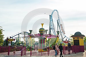 Helsinki, Finland - 21 May 2023: View of Linnanmaki amusement park with rides roller coaster Taiga and carousel Poppis