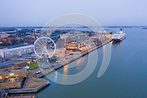 HELSINKI, FINLAND - NOVEMBER 2019: Helsinki. Finland. Ferris wheel in Helsinki. The embankment of the quay of Katajanokka. Uusimaa